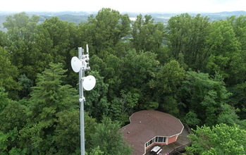 Signal tower above trees.